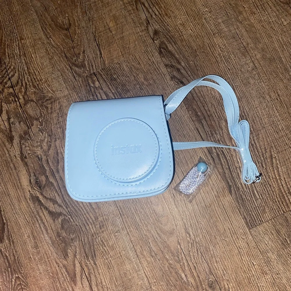Baby Blue Polaroid Camera with photo book, film, and etc.